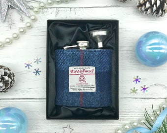 May include: A blue and red Harris Tweed hip flask with a silver funnel in a black box. The flask is made of 100% pure new wool.
