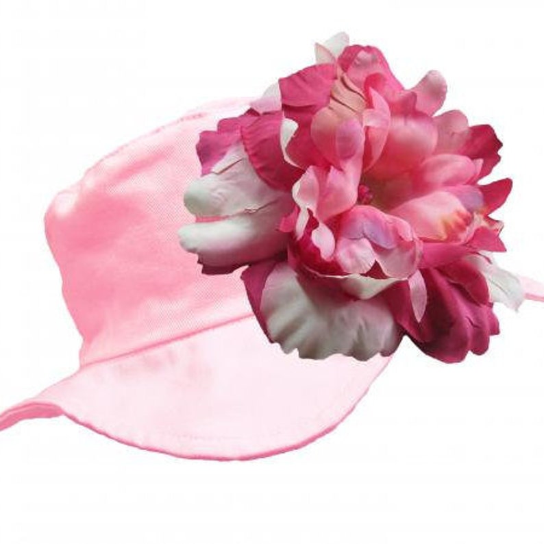 May include: A pink sun hat with a large pink flower on the side.