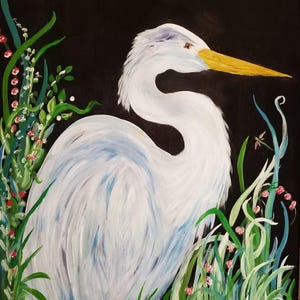 May include: A white egret with a yellow beak stands in a field of green grass and pink flowers against a black background.