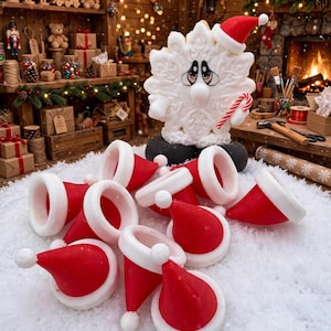 May include: A white snowflake figurine with a sad expression, wearing a red and white Santa hat and holding a candy cane, stands behind a pile of small red and white Santa hat ornaments scattered on a white, snowy surface.
