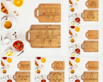 May include: A set of 10 personalized bamboo cutting boards with engraved names and initials. The boards are in various sizes and feature different designs, including a wreath, a monogram, and a simple name.