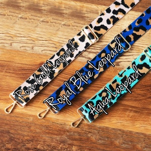 May include: Three different leopard print fabric straps with gold hardware. The straps are labeled "Rose Gold Leopard", "Royal Blue Leopard", and "Aqua Leopard".