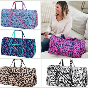May include: Four different patterned duffel bags. The bags are all the same size and shape, but have different patterns. The patterns include a blue and pink paisley design, a blue and green geometric design, a pink and black leopard print, and a black and white zebra print.