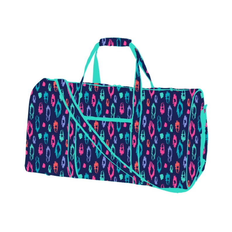 May include: A teal blue duffel bag with a colorful ikat pattern. The bag has a top handle and a shoulder strap.