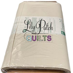 May include: A bundle of quilt batting wrapped in clear plastic. The label reads "Lily Patch Quilts" in cursive script, with the word "QUILTS" in a colorful block font. The batting appears to be a light beige color.