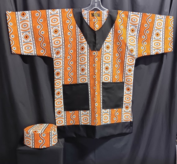 African Dashiki. Colors orange, grey and black trimmed with solid black fabric. Matching Kufi sold separately.