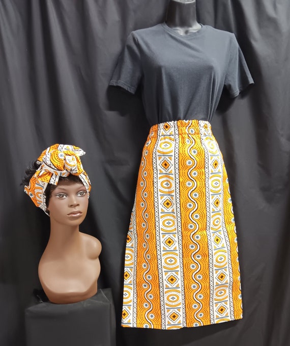 African Print Skirt, elastic waist with pockets, headwrap. Colors black, yellow, white and gray mid-ankle length. 100% Cotton. Free Shipping