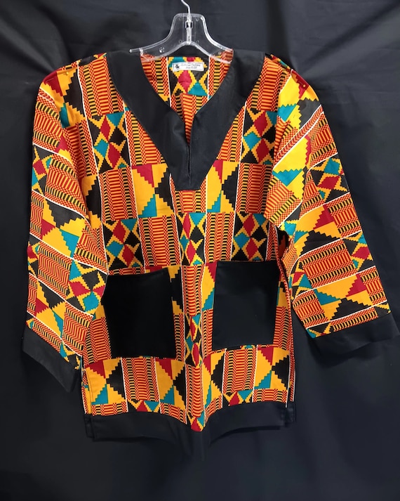 African Dashiki, beautiful Kente print black, blue, red, yellow colors. Long sleeves trimmed in black and black pockets. Kufi sold separate.
