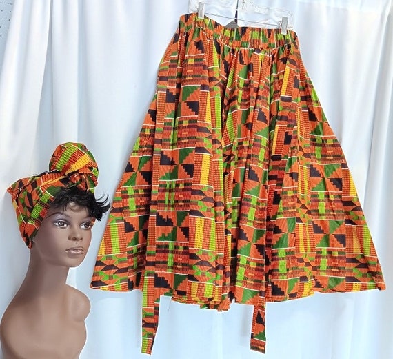 African women's Kente skirt, 8 panels, mid length, waist tie belt, pockets and headwrap.