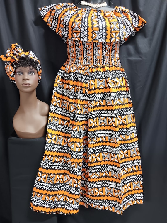 African print Jumper with palazzo legs. Sleeveless, over shoulder collar, Elastic top to waist, ankle length, pockets, matching headwrap.