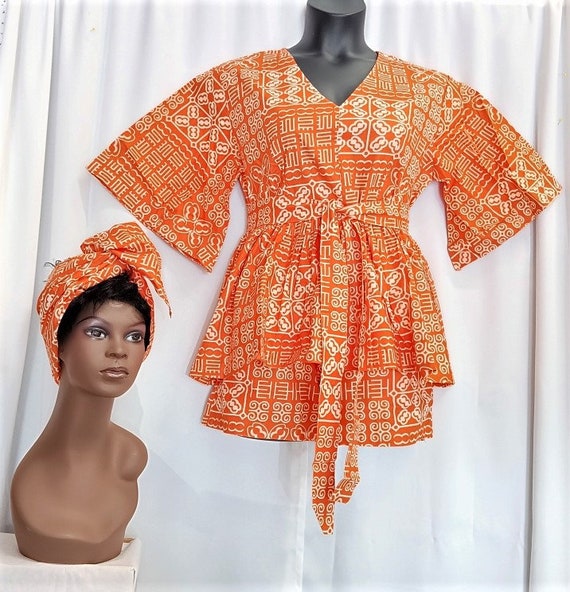 African women's 4-piece short set, (Top, shorts, tie belt, and headwrap). Orange and white west African symbol print fabric.