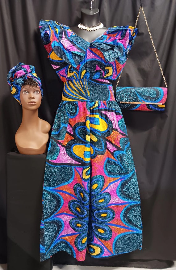 Africa print 3pc Jumper with headwrap and matching purse. Double collar sleeveless. Zipper back, Elastic waist, ankle length palazzo legs.