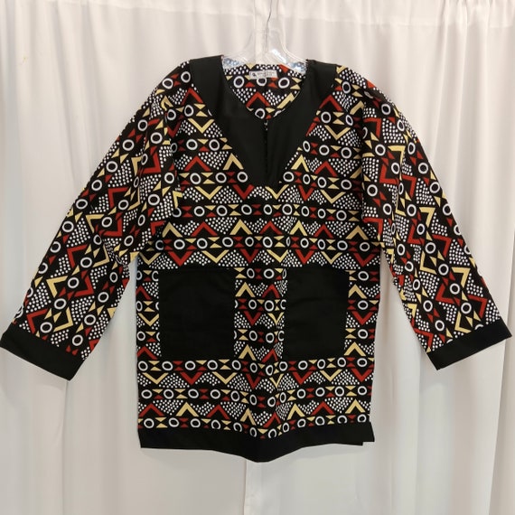 African Dashiki, black, dark reddish brown, yellow and white. Long sleeves trimmed in black matching Kufi Print, sold separately.
