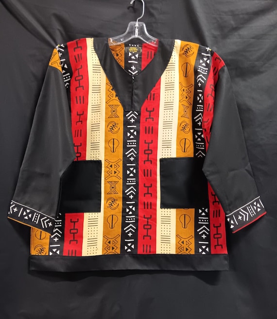 African inspired Dashiki, black, red, beige and white symbol print. Long solid black sleeves, pockets and trim. Matching kufi sold separate.