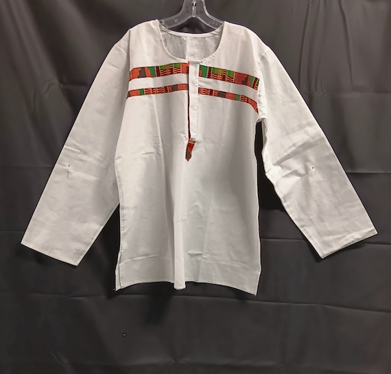 African inspired long sleeve shirt. African print and solid white linen like fabric makes nice contrast. Button down neck.