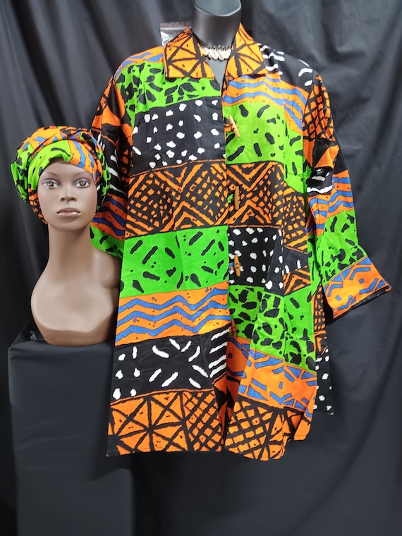 African print Jacket dress with matching head wrap. Green, orange,blue, black and white, swing style. Wooden Button-down front with pockets.