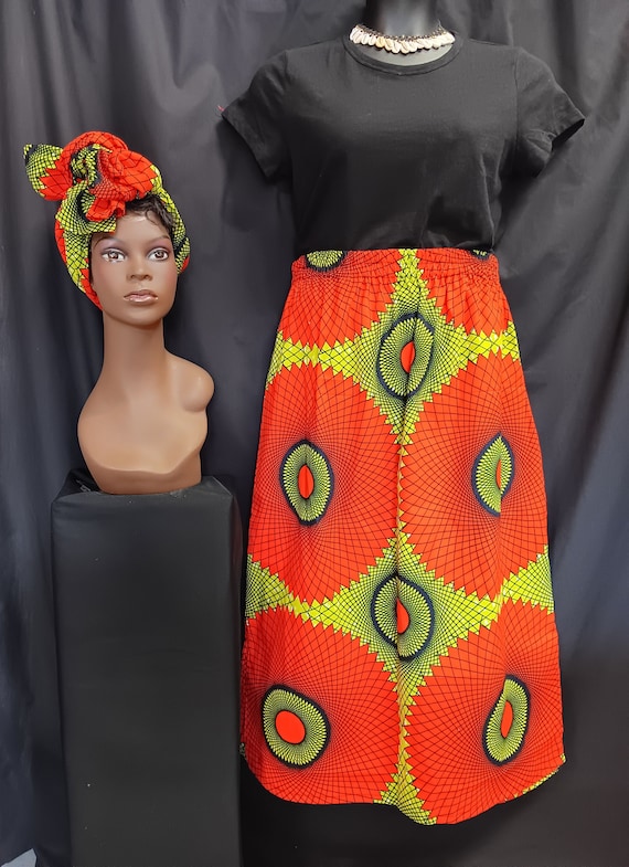 African Print Skirt, matching headwrap, elastic waist with pockets, ankle length. Green, reddish-orange, black. 100% Cotton. Free Shipping.