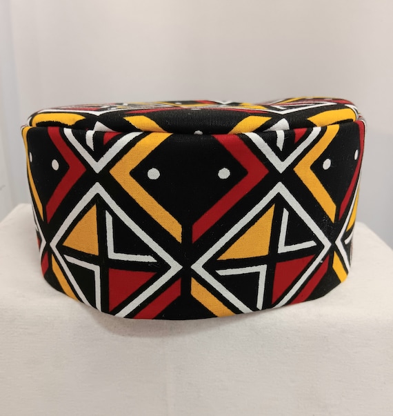 African kufi yellow, red, black and white print.