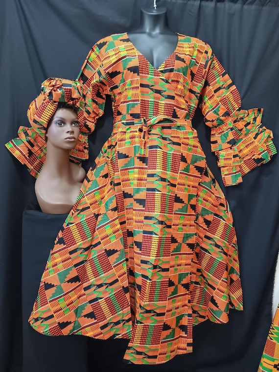 African print wrap dress with matching headwrap. Ankle length, long sleeves 3 ruffle sleeve bottom. Kente print. 20% off. Free Shipping.