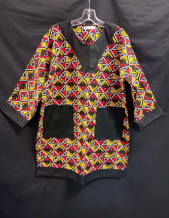 African Dashiki, black, yellow, red and white. Long sleeves African print and solid black trim.  Matching Kufi, sold  separately.