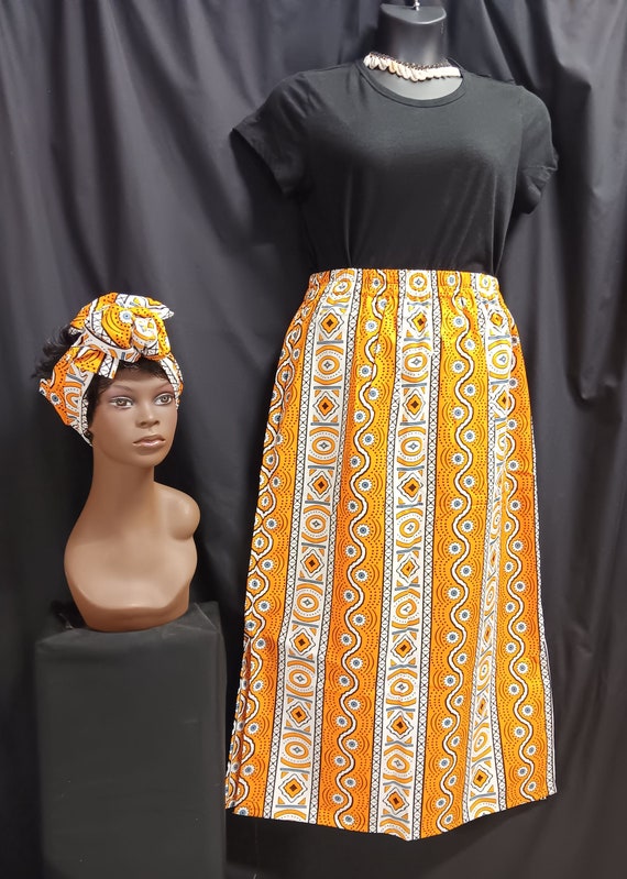 African Print Skirt, elastic waist with pockets, headwrap. Colors black, yellow, white and gray ankle length. 100% Cotton. Free Shipping