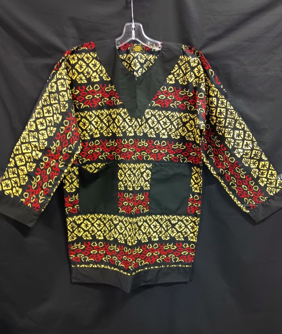 African inspired Dashiki, red, black and light yellow. Long sleeves trimmed in black and pockets. Matching Kufi Print, sold separately.