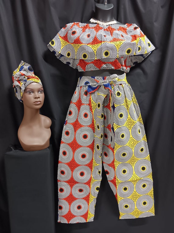 Africa print Women's 3-piece crop top pants set matching headwrap. Sleeveless over shoulder collar elastic waist. Tie belt pants, pockets.