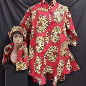 May include: A red and gold patterned shirt with a matching head wrap. The shirt has a button-up front and long sleeves. The head wrap is tied around the head and has a decorative design.