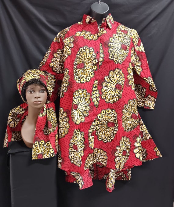 African print shirt dress. Button-down front with pockets, high front and lower back, with wide flare bottom. Great with leggings.