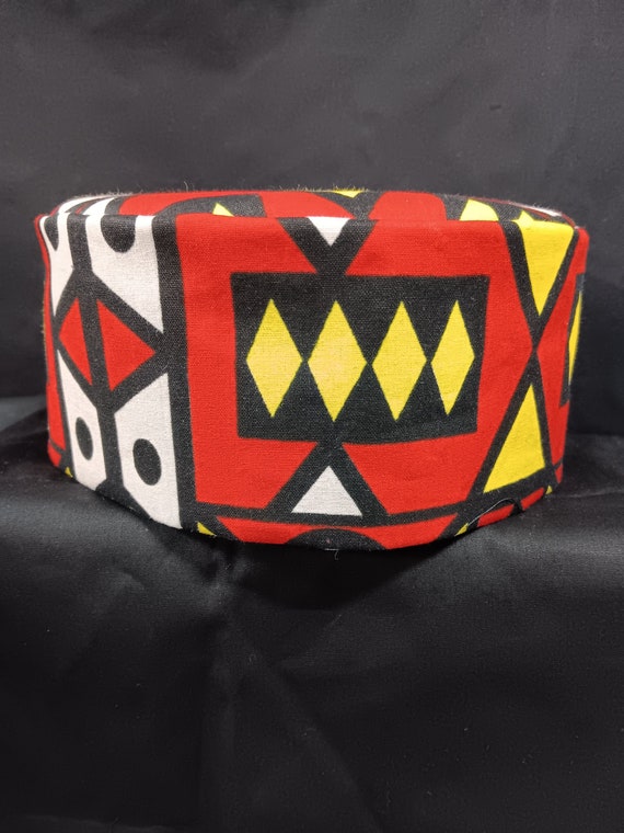 African inspired kufi hat abstract vibrating print, beautiful colors, black, yellow, red, and white.