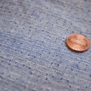 May include: A copper-coloured US penny coin with the words "One Cent" and an image of the Lincoln Memorial.