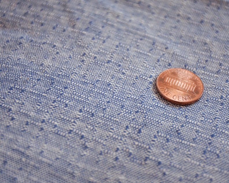 May include: A copper-coloured US penny coin with the words "One Cent" and an image of the Lincoln Memorial.