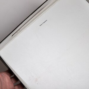 May include: A white rectangular tray with a black border. The tray has the text "Made in Malaysia" printed on it.