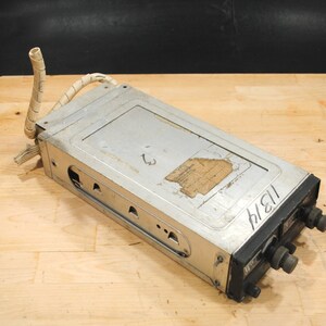 May include: A silver and black vintage radio with a white cord and the text "11/21" written on the side.