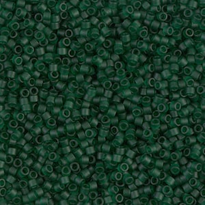 May include: A close-up image of a large quantity of small, round, opaque green beads. The beads are arranged in a random pattern, creating a textured surface.