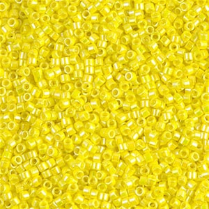 May include: A close-up image of a large quantity of small, bright yellow seed beads. The beads are round and have a slight iridescent sheen.