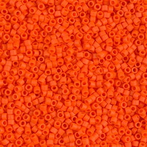 May include: A close-up image of a large quantity of small, bright orange round seed beads. The beads are all the same size and shape, and they are arranged in a random pattern.