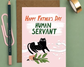 May include: A Father's Day card with a pink background features a black cat with a white bandage, a broken plant pot, and the text "Happy Father's Day HUMAN SERVANT" in orange and green. A pencil, paperclip, and tape are also visible.
