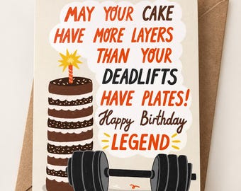 May include: A greeting card featuring a tall chocolate cake with a single candle and a black barbell. The text reads: MAY YOUR CAKE HAVE MORE LAYERS THAN YOUR DEADLIFTS HAVE PLATES! Happy Birthday LEGEND. The design uses orange and dark brown text.