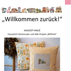 May include: Two decorative cushions. One features a floral pattern with yellow and orange flowers on a white backdrop. The other has a square embroidered design of a house and tree on a grey background. Text on the image reads "Willkommen zurück!"