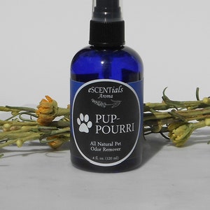 May include: A blue glass bottle with a black spray nozzle and a white label that reads "eSCENTials Aroma PUP-POURRI All Natural Pet Odor Remover 4 fl. oz. (120 ml)".