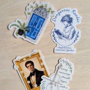 May include: Four stickers with literary and musical themes. One sticker features a blue door with ivy, another says "Dangerous Reader", a third shows a portrait, and the last has a cello illustration with the text "every morning should begin with a cello."