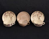 Three antique Japanese Satsuma pottery cup and saucer sets