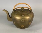 An antique Chinese brass teapot with applied medallions, late Qing Republic period