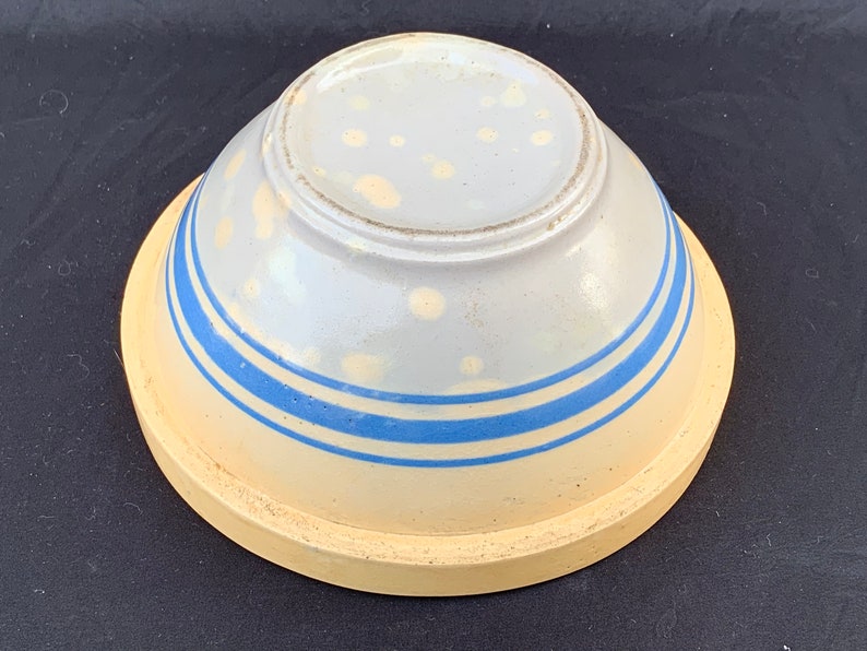 An antique banded yelloware mixing bowl