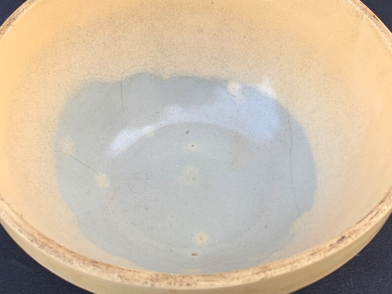 An antique banded yelloware mixing bowl