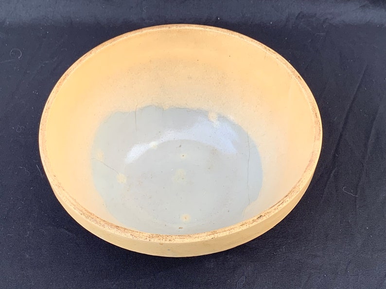 An antique banded yelloware mixing bowl