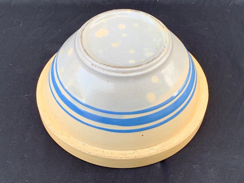 An antique banded yelloware mixing bowl