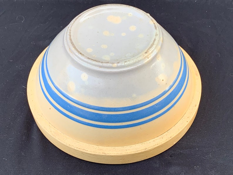 An antique banded yelloware mixing bowl