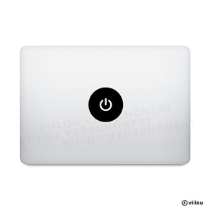 Può includere: Un laptop bianco con un adesivo nero del pulsante di accensione al centro. Il pulsante di accensione è un cerchio nero con un simbolo di accensione bianco. Il laptop ha angoli arrotondati e una superficie liscia.